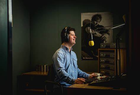A person with Down syndrome working at a radio station