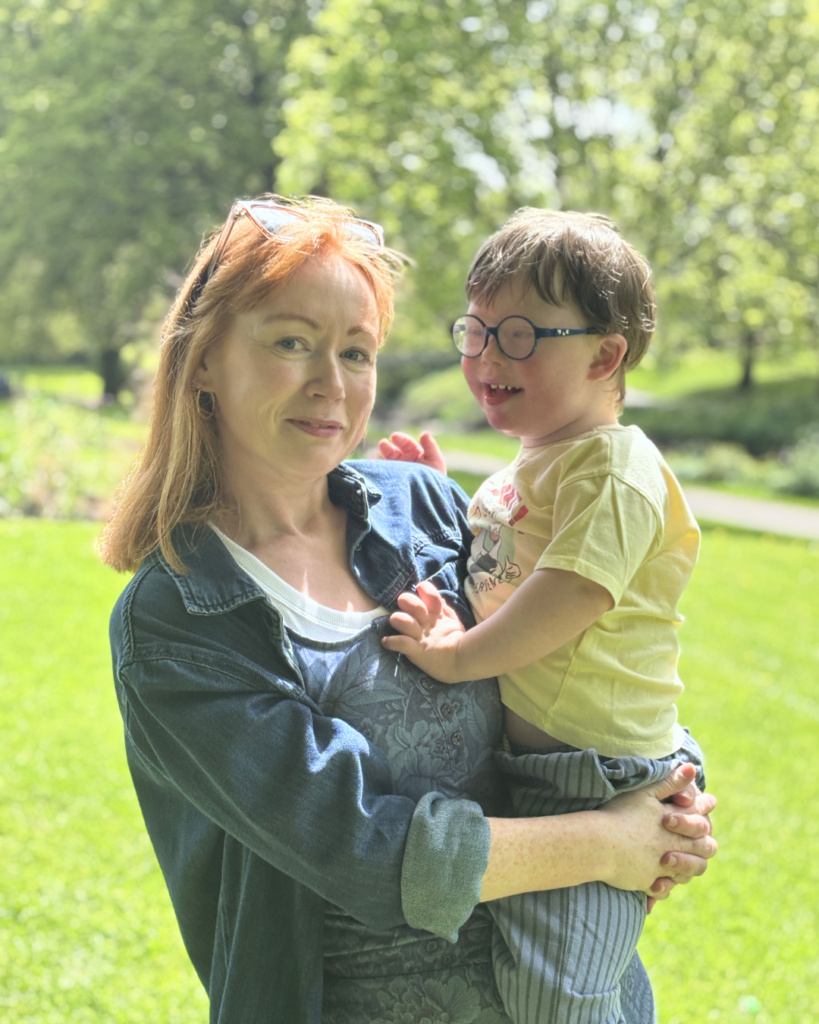 Boy with Down syndrome in park with mum