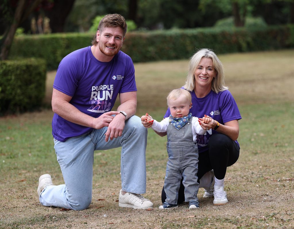 Picture of a lady and her baby with Down syndrome in a park with Rugby star Joe McCarthy in Purple t-shirts